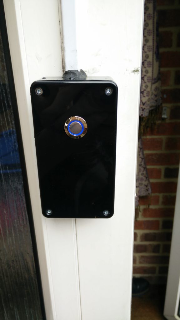Doorbell with blue LED ring mounted in enclosure